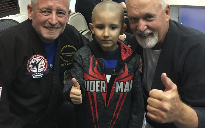 Image of Aiden Wallace, center, was awarded an honorary black belt.