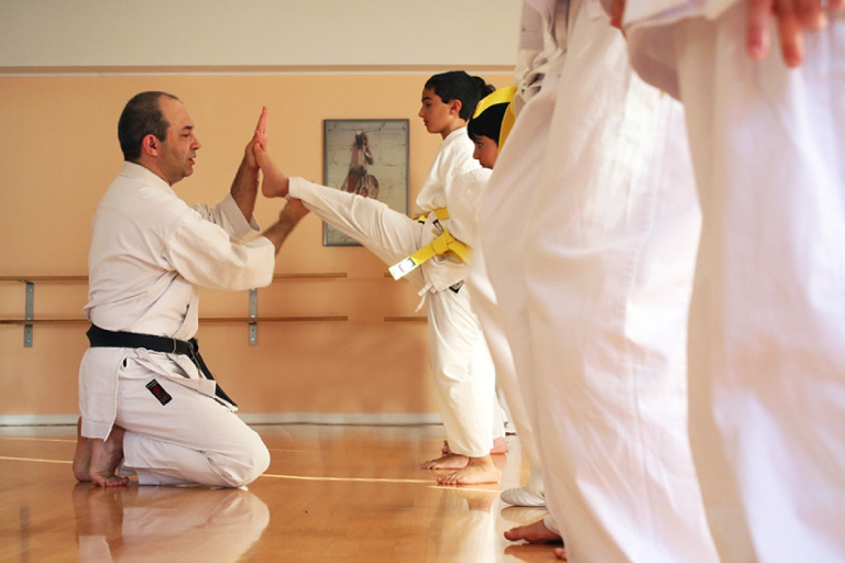 Image Showing a karate coach teaching an attitude to his student.