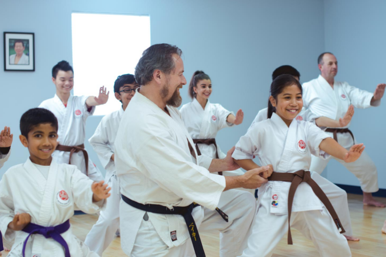 Image showing happy coach given karate training to his students in a training session.