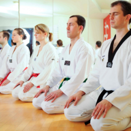 Group of Young Students Sits on their knees in the floor.