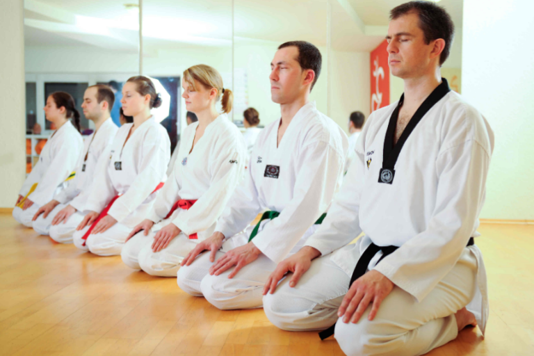 Group of Young Students Sits on their knees in the floor.