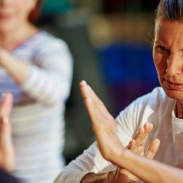 Mature Woman Fighter Repeating After Her Instructor.