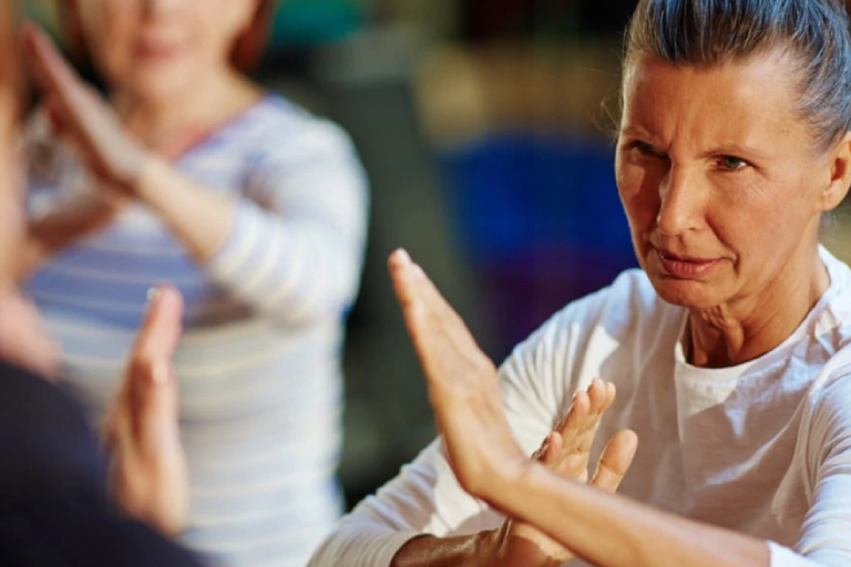 Mature Woman Fighter Repeating After Her Instructor.