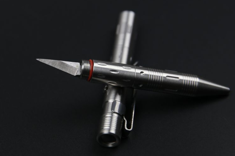 Pen Knife Placed On The Table - Self Defense Weapon.