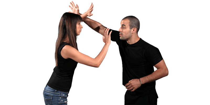 Martial Arts Instructor Exercising With Young Girl.