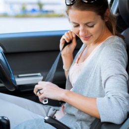 A Young Woman Wearing Her Seat Belt Before Start Driving.