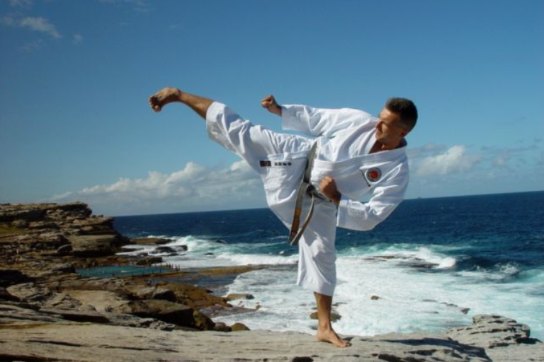 Man in Yellow Kimono Standing in Karate Pose with Raised Hands · Free Stock  Photo