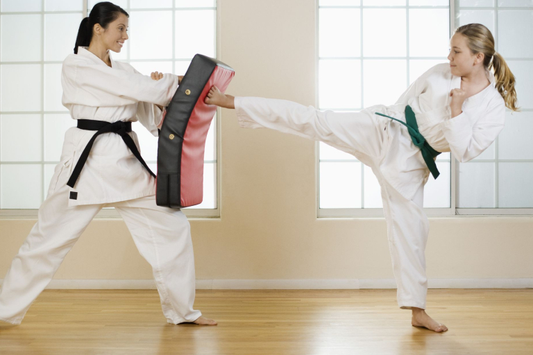 Two Woman In Their Martial Arts Training.