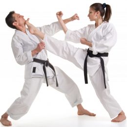 A Female Fighter Doing Front Kick On Her Defender.