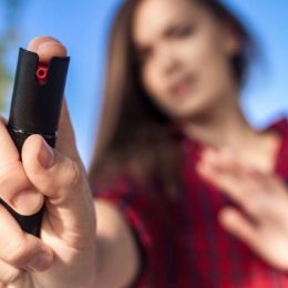 A Young Girl Holding Her Pepper Spray For Self Defense.