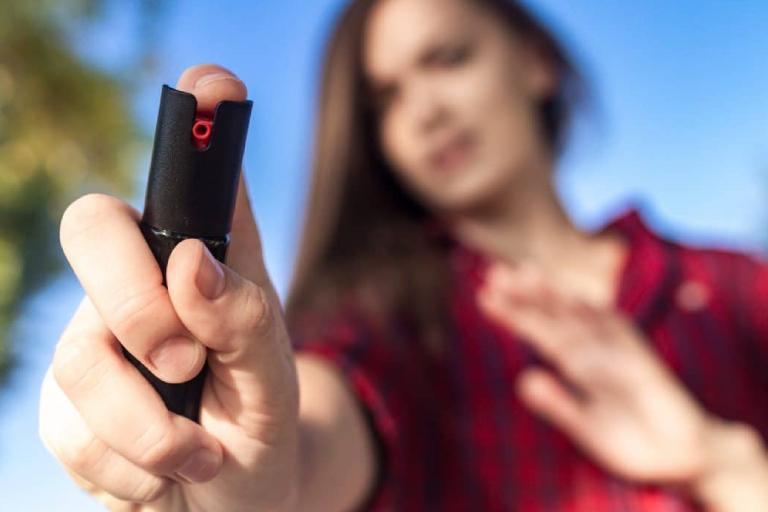 A Young Girl Holding Her Pepper Spray For Self Defense.