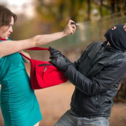 A Woman Defending A Robber By Pepper Spray.