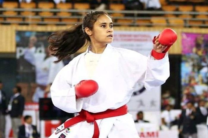 A Young Woman In An Action On A Karate Tournament.