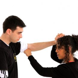 A Woman Defending A Man Pulling Her Hair.