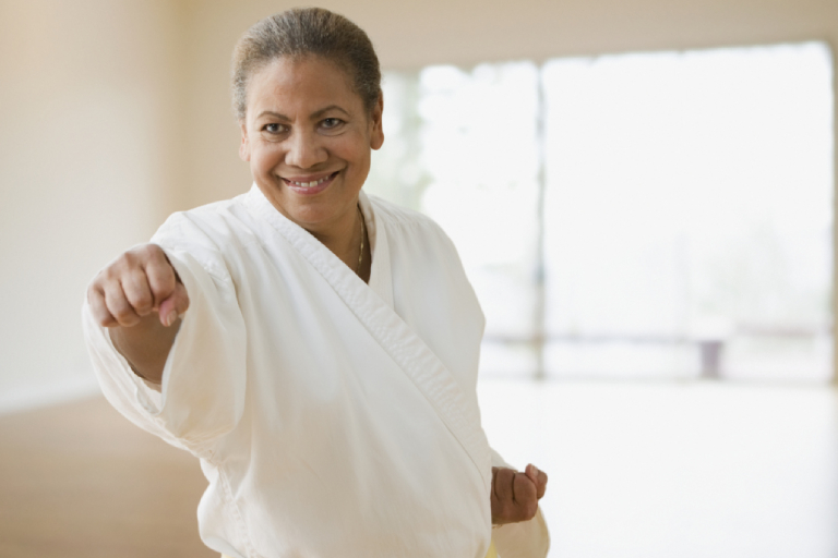 A Senior Woman Punching At The Camera.