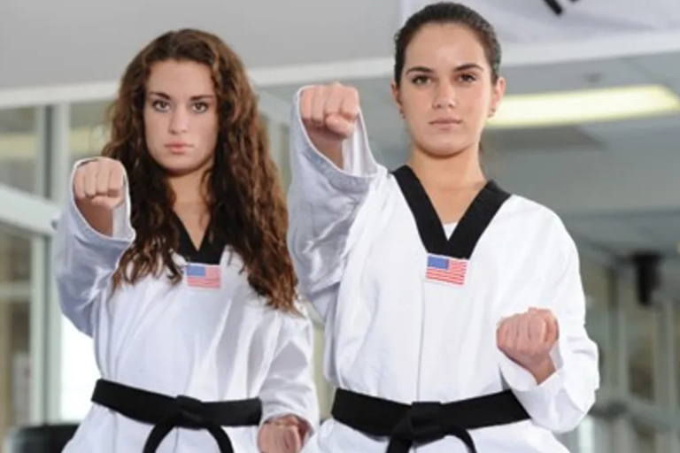 Two Female Fighters Punching At The Camera.