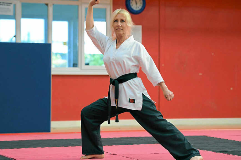 A Senior Female Martial Art Fighter In Her Training Session.